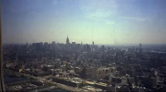 The midtown Manhattan skyline with the Empire
                        State Building rising above it, seen from a
                        light aircraft over the Hudson heading north.